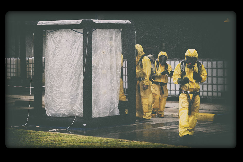 Personnel near a decontamination tent