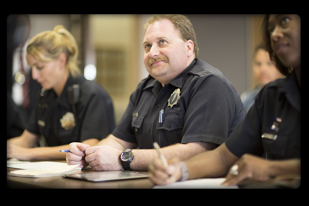 Three officers in a debriefing session
